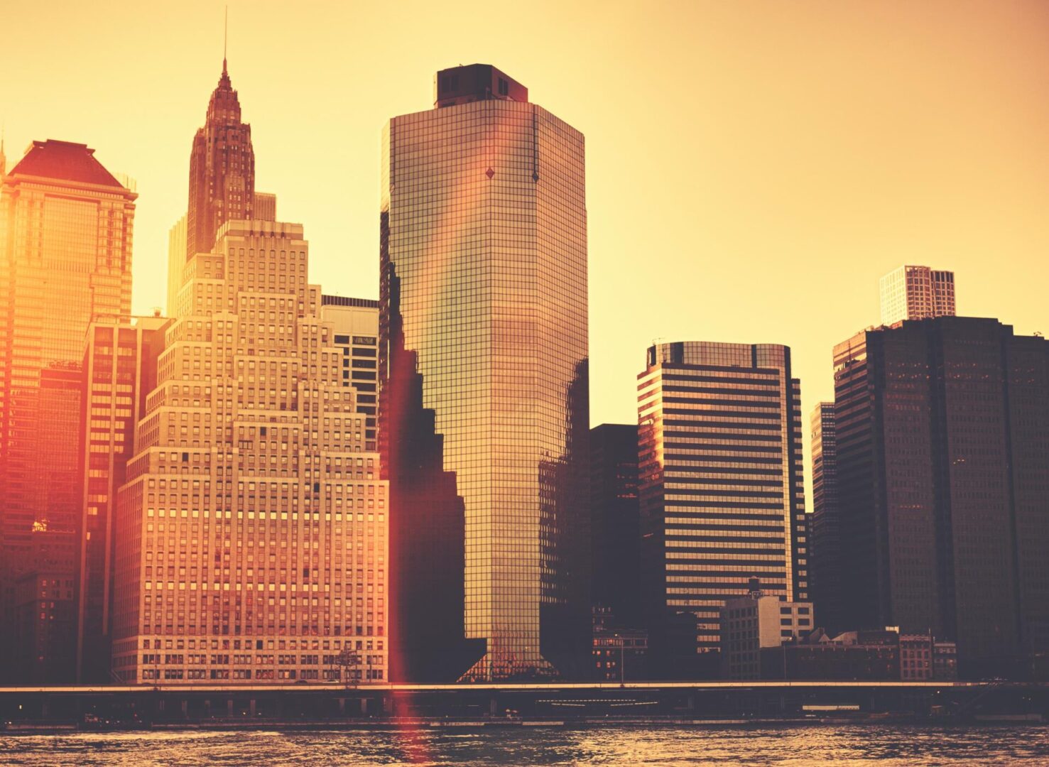 Sunset city skyline with reflective skyscrapers